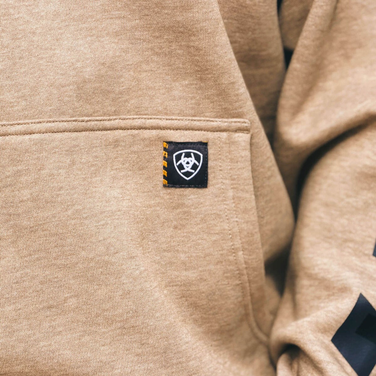 Ariat I-State Oatmeal Hood kangaroo pocket logo close up